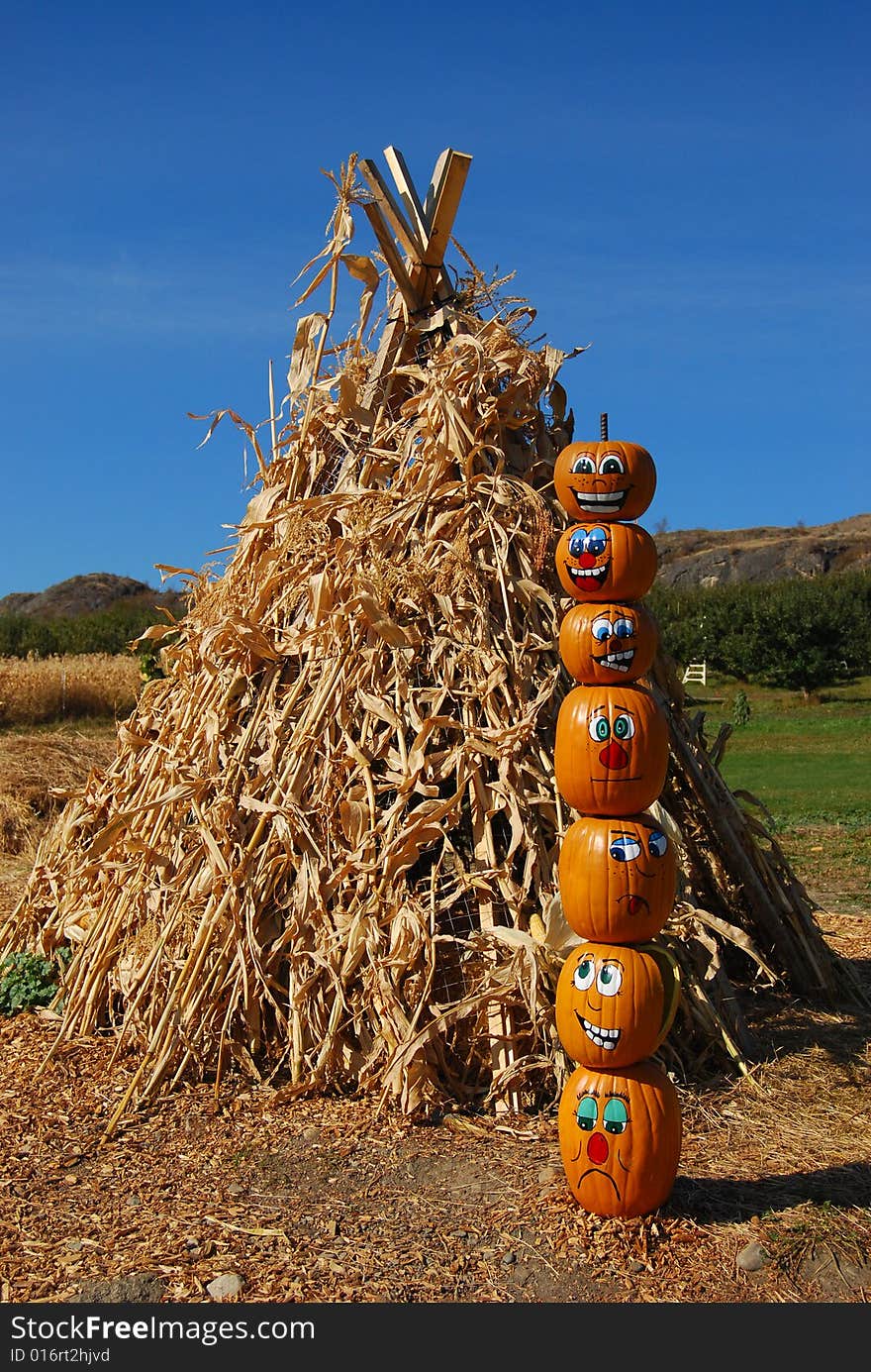 Pumpkin puppets totem pole on a farmers market