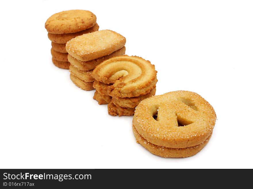 Many pieces of cookies stacked on white background.