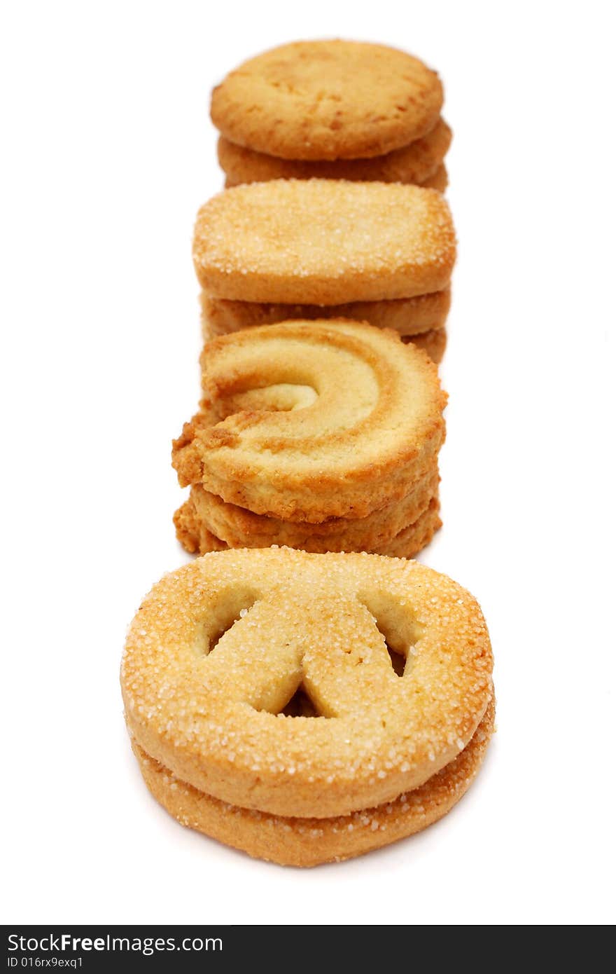 Many pieces of cookies stacked on white background.