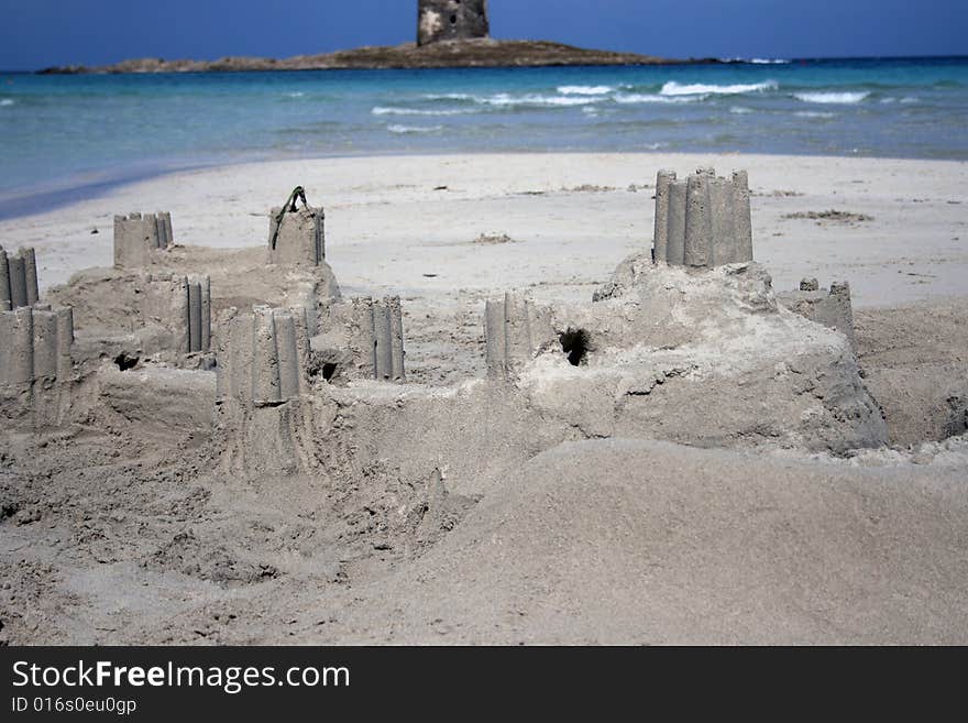 Sand castle with real castle as a background, Stintino, Sardinia island, Italy. Sand castle with real castle as a background, Stintino, Sardinia island, Italy