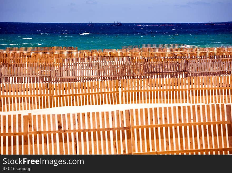 Wooden fence on deserted beach dunes