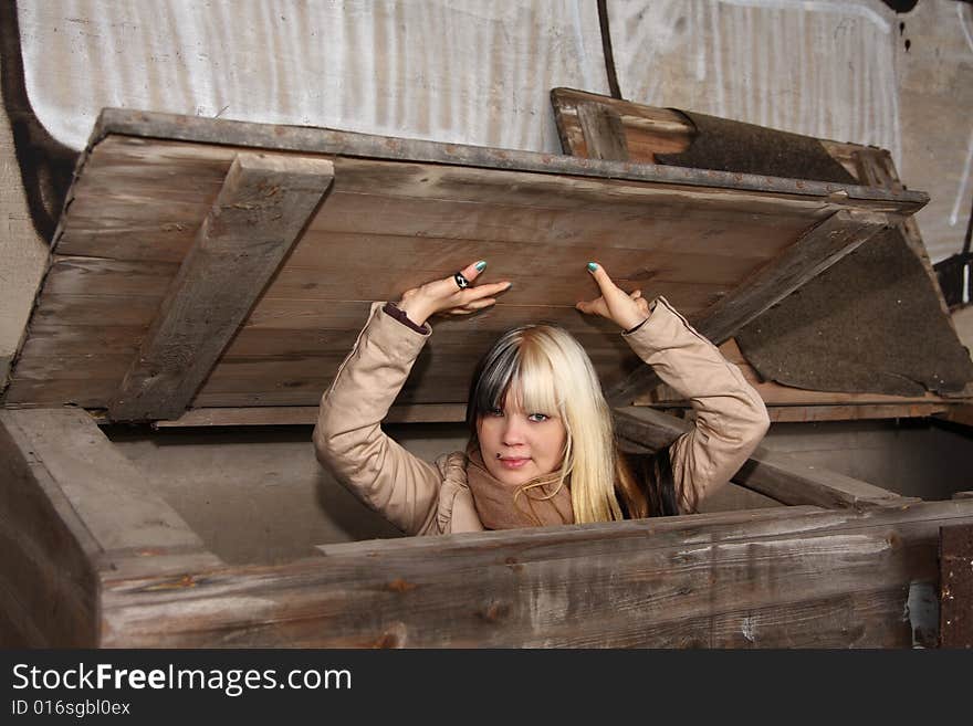 Beautiful young woman, fashion model, black and blond hair in industrial location