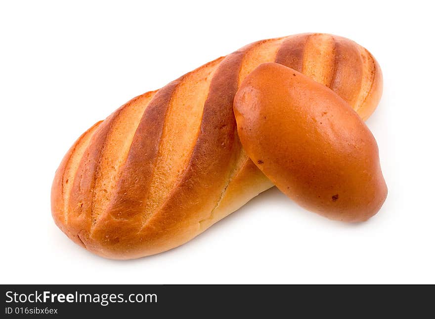 Rich tasty pie lays on cut long loaf bread baked wheat flour on white background