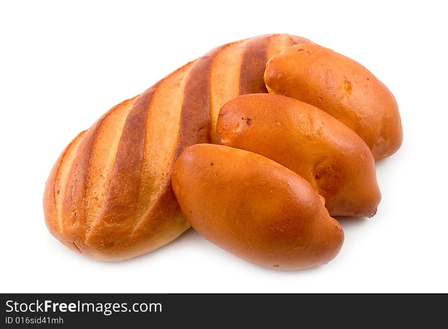 Rich tasty pie lays on cut long loaf bread baked wheat flour on white background