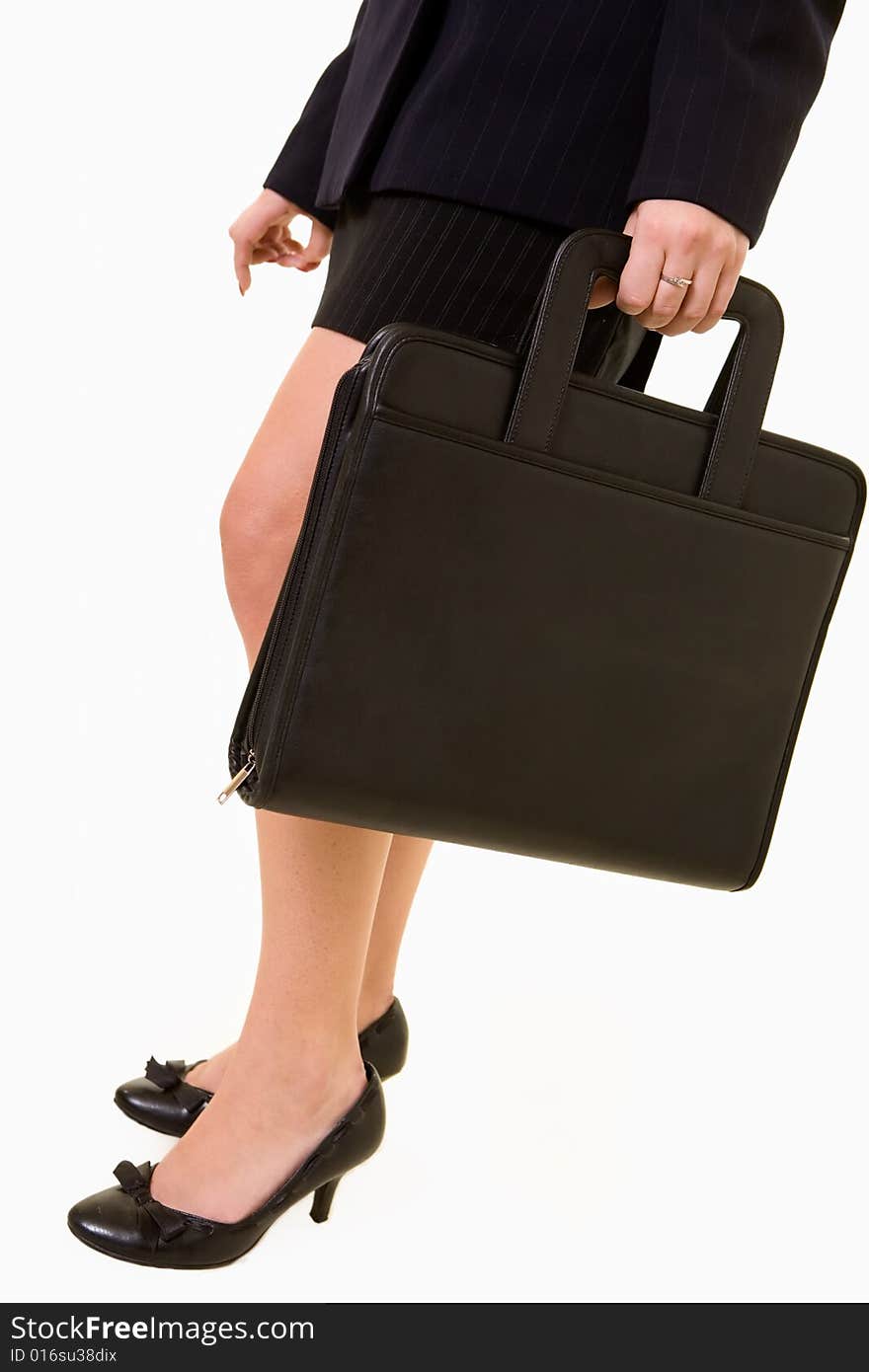 Legs of business woman standing on white wearing black skirt and carrying a briefcase or portfolio. Legs of business woman standing on white wearing black skirt and carrying a briefcase or portfolio