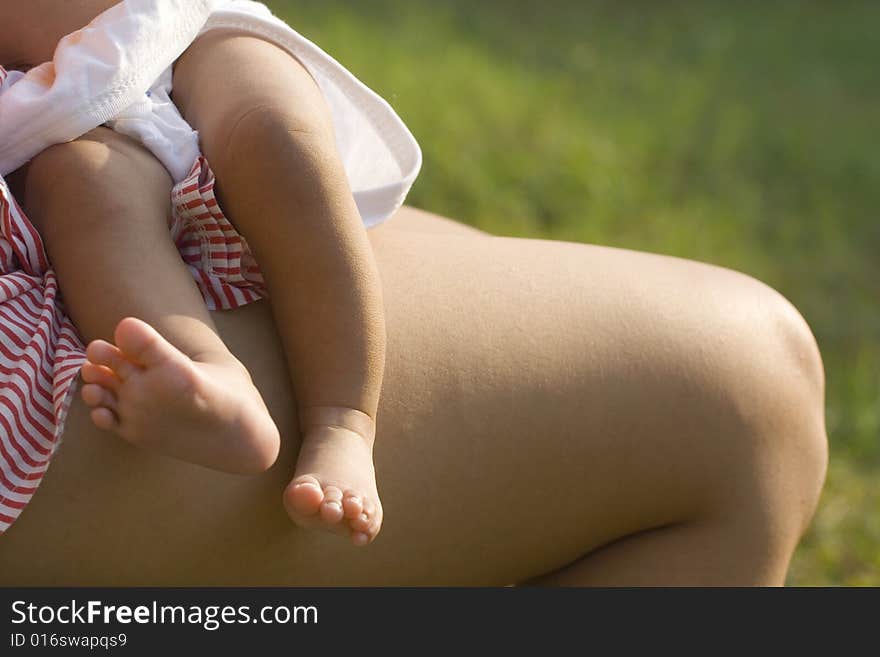 Mother and baby sunbathing