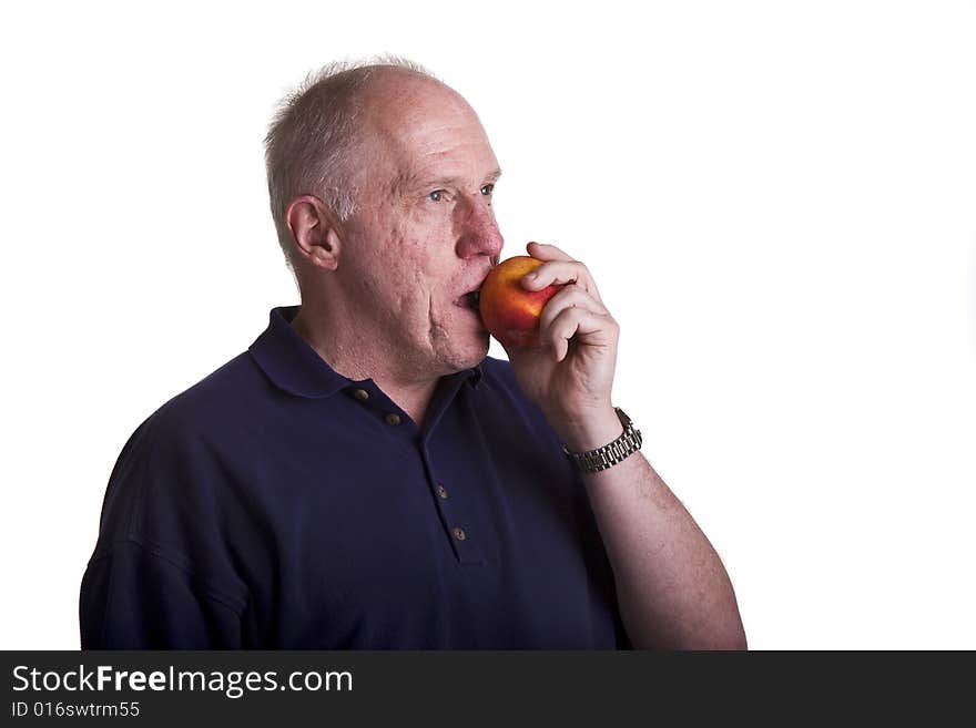 An older man enjoying a healthy snack. An older man enjoying a healthy snack