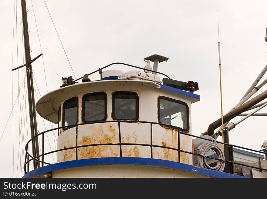 Cabin of an old rusty tugboat with a seagull on top. Cabin of an old rusty tugboat with a seagull on top