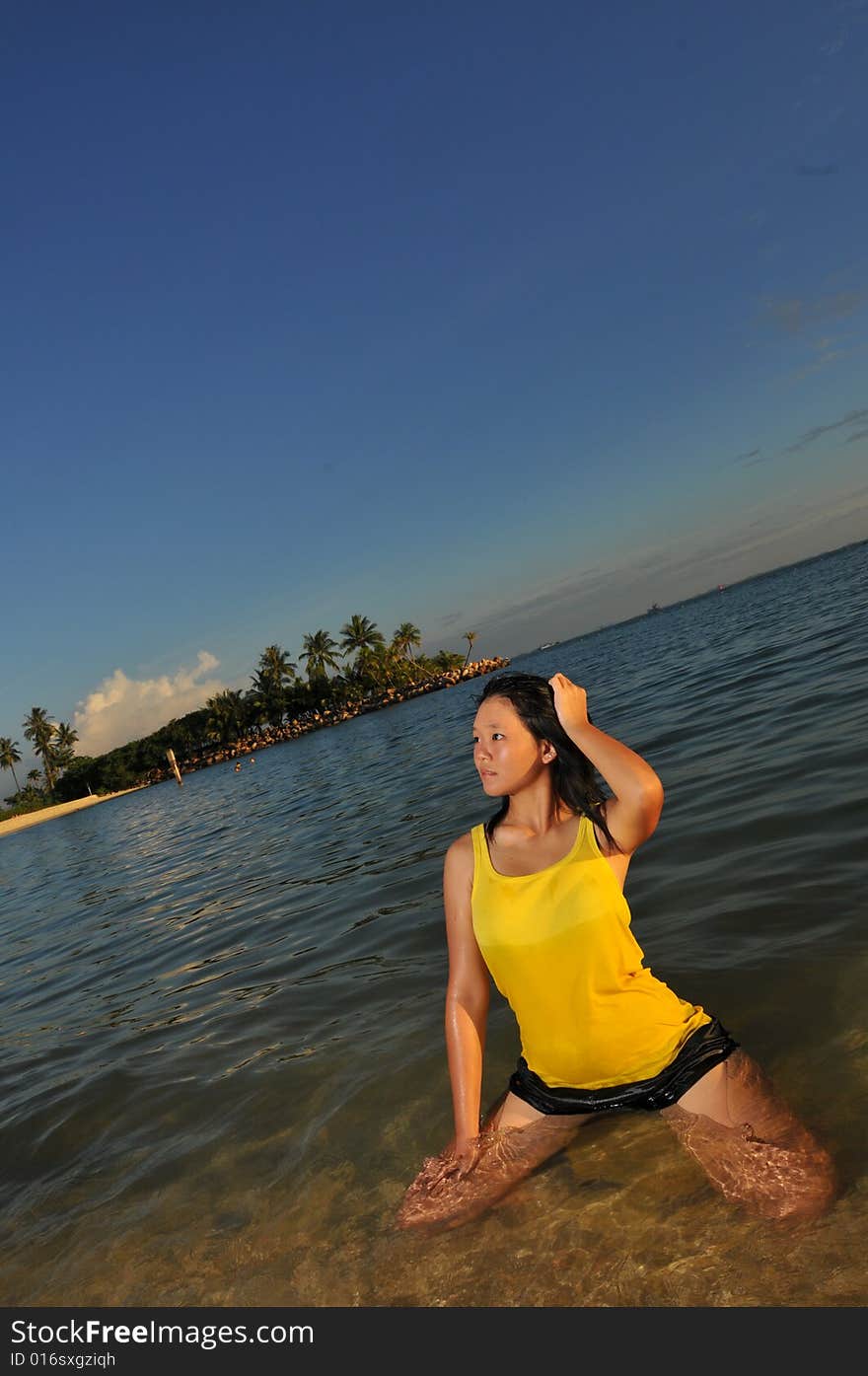 Woman posing in water at the beach. Woman posing in water at the beach.