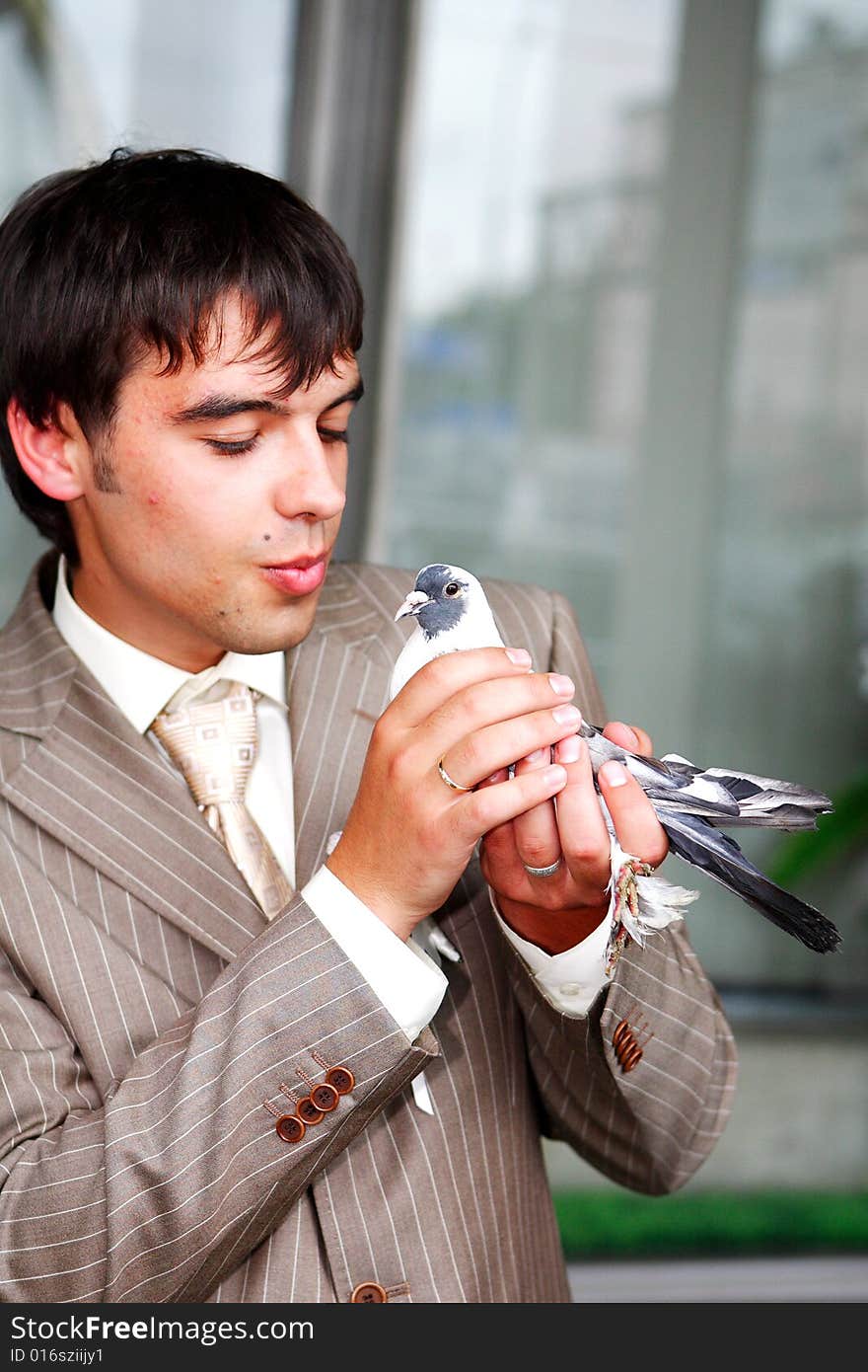 The man costs in a jacket. At it in hands a pigeon