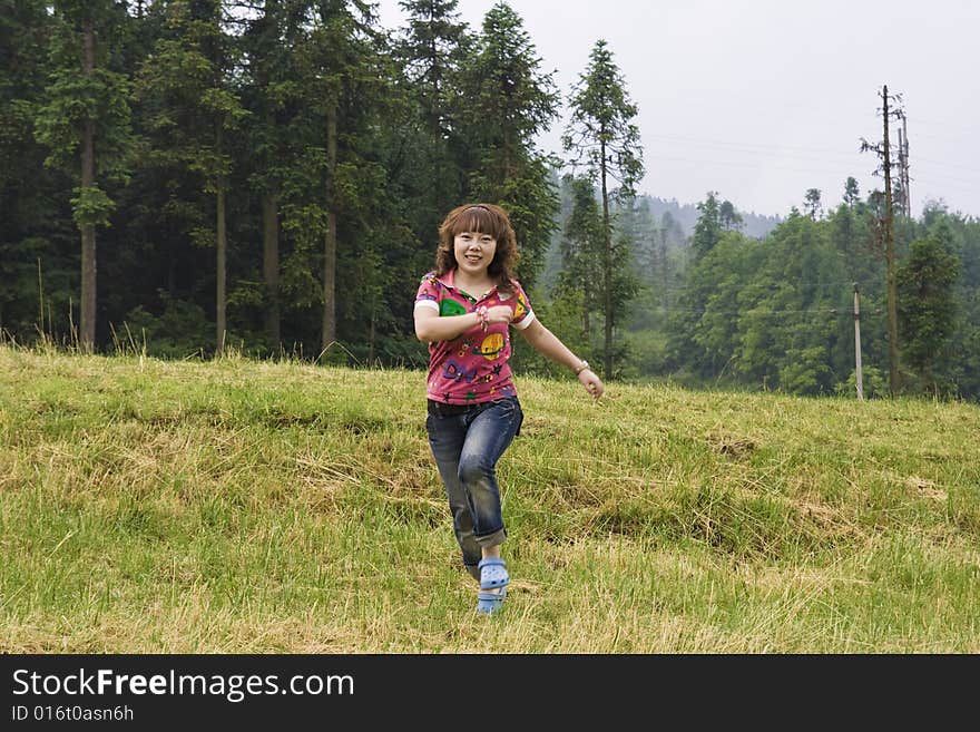 A girl running on the Grassland. A girl running on the Grassland