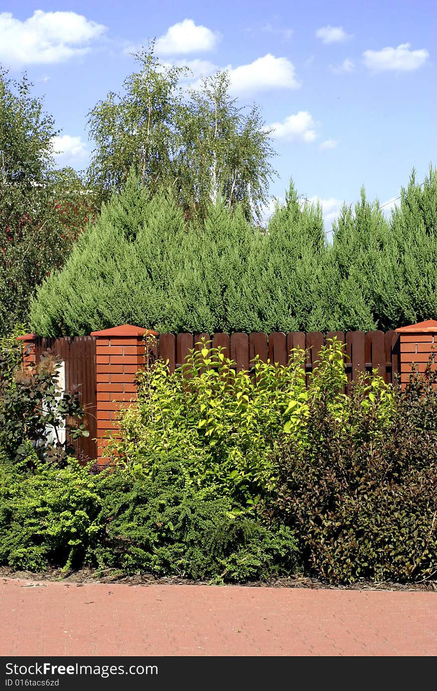 Beautiful garden setting and brown picket fence