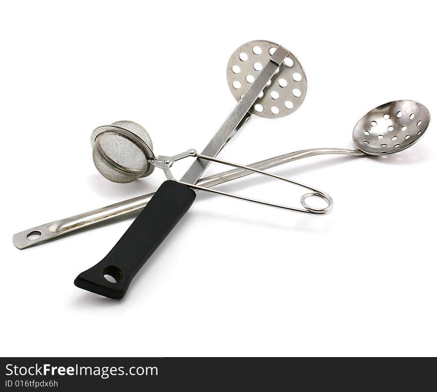 Two perforated spoons and tea strainer isolated on a white background