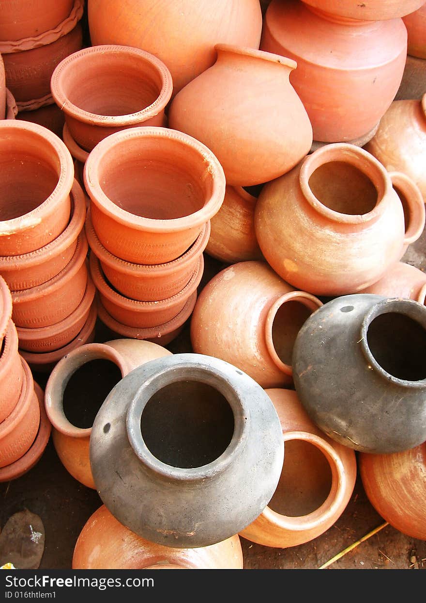 A group of different shaped earthen pots made out of clay