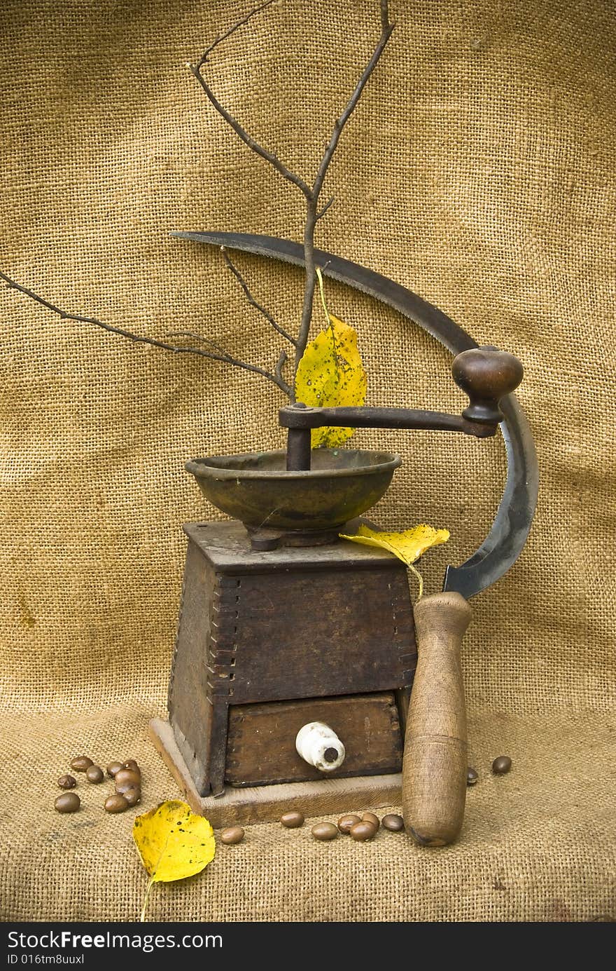 A coffee mill and a sickle in the mood of autumn