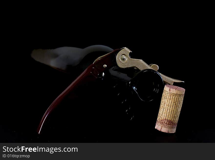 Corkscrew for opening wine bottles on black background