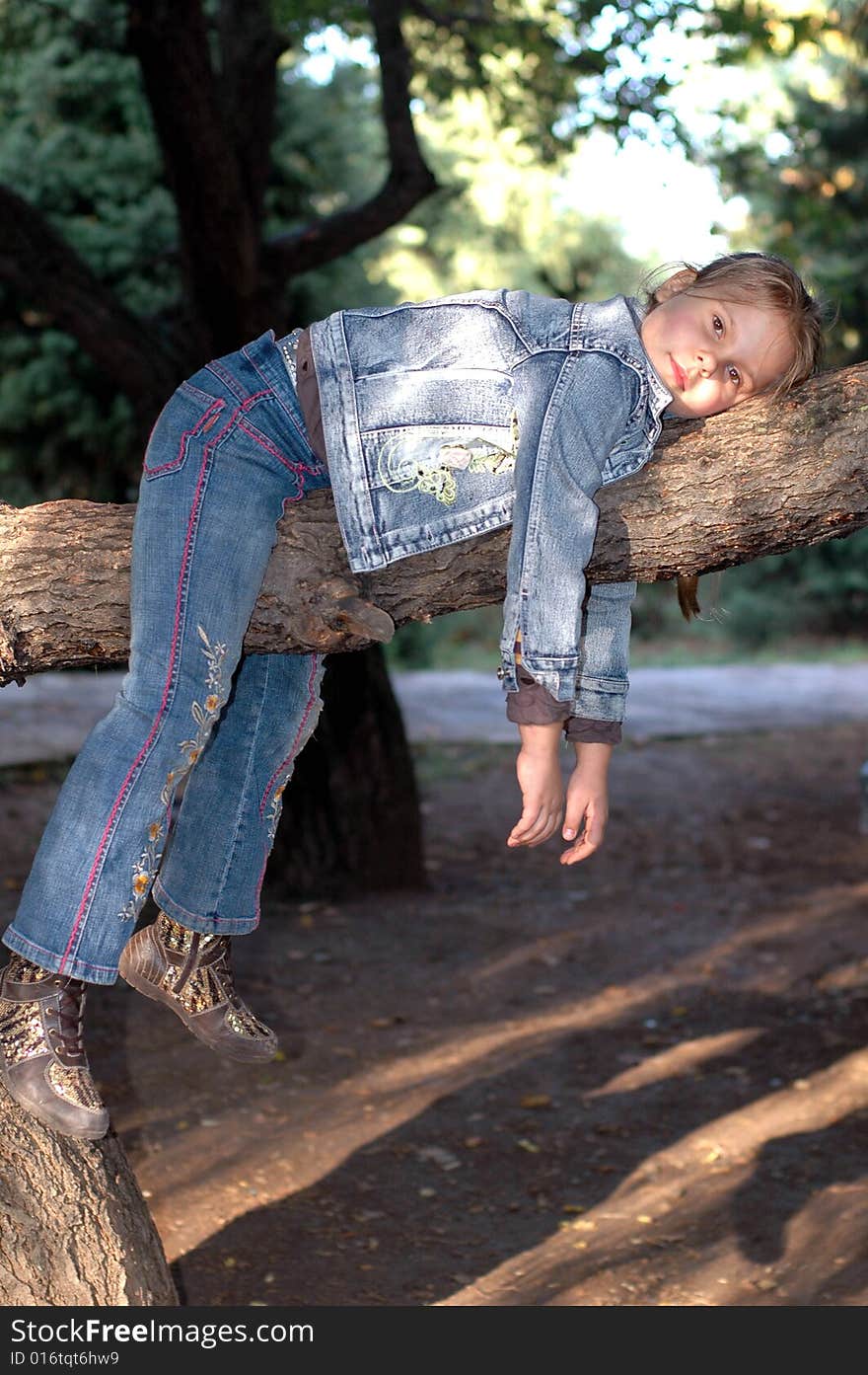 Little girl lieing on the tree. Little girl lieing on the tree