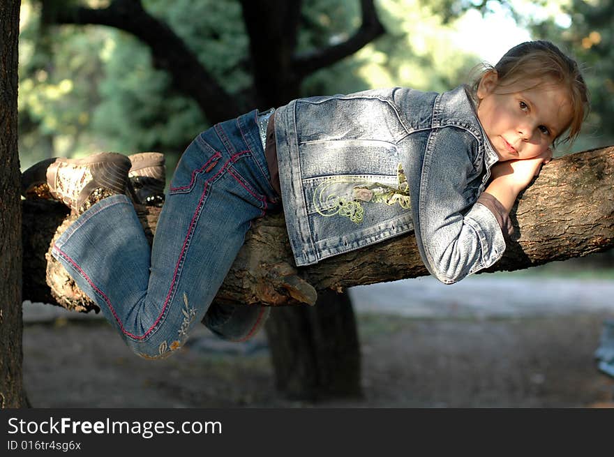 Little girl lieing on the tree. Little girl lieing on the tree