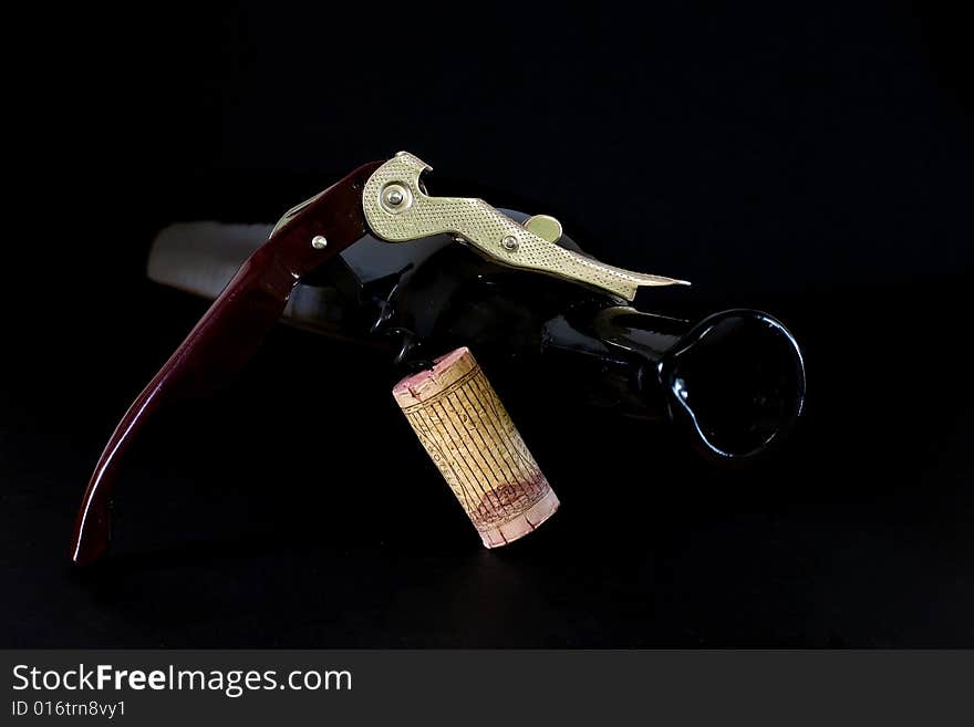 Corkscrew for opening wine bottles on black background