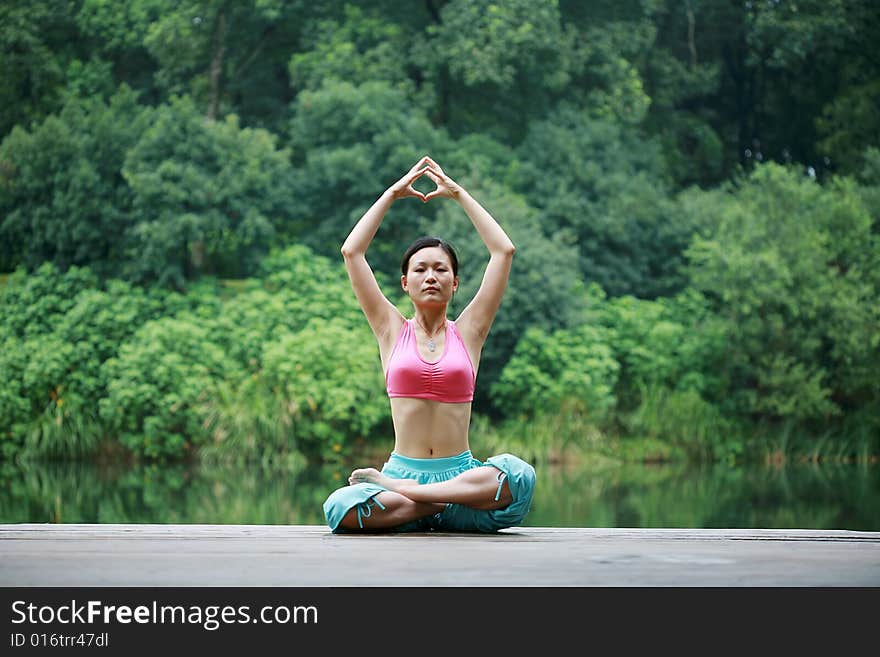 Young Chinese Woman Practicing Yoga Outdoor