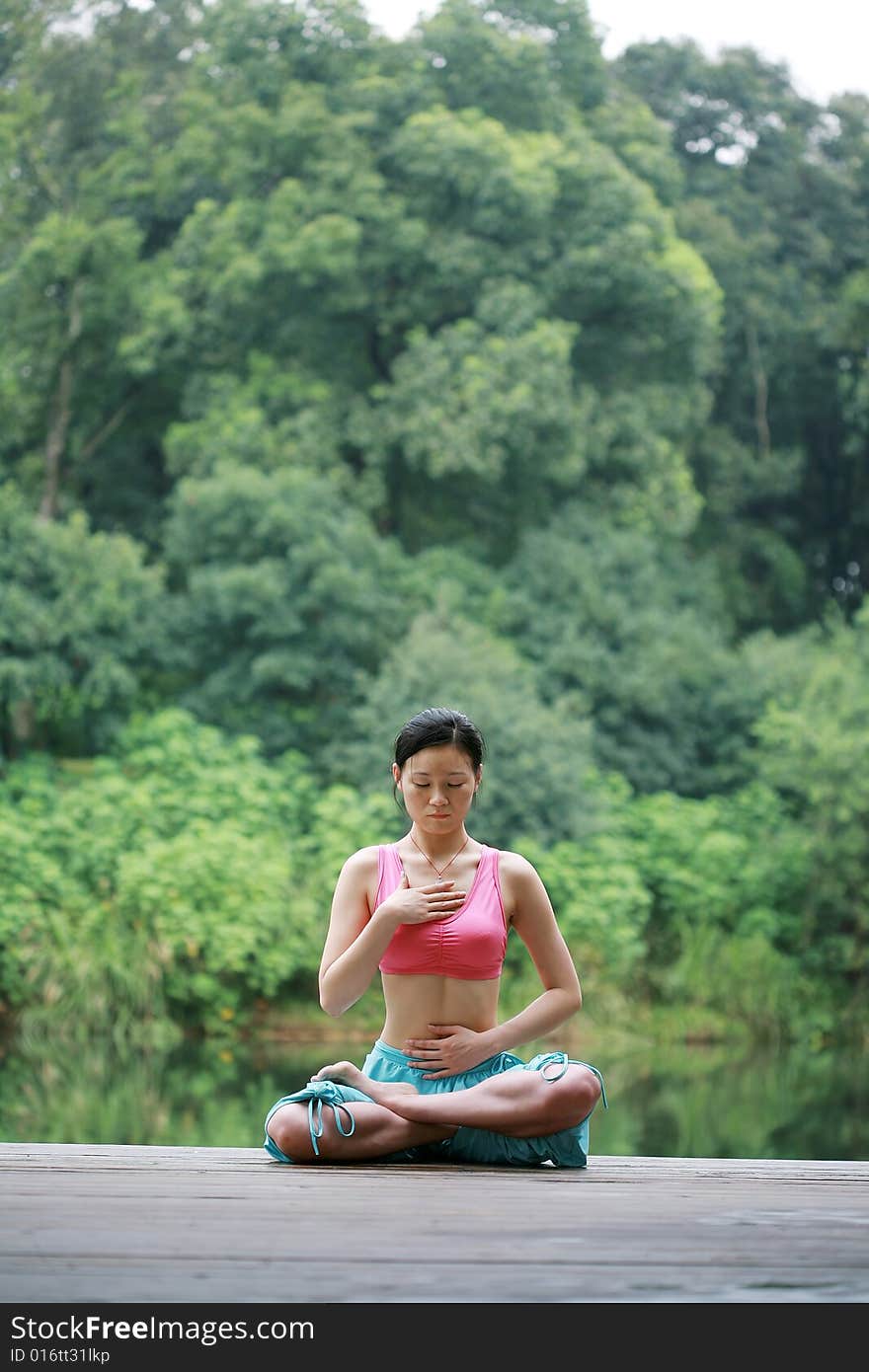 Young Chinese Woman Practicing Yoga Outdoor