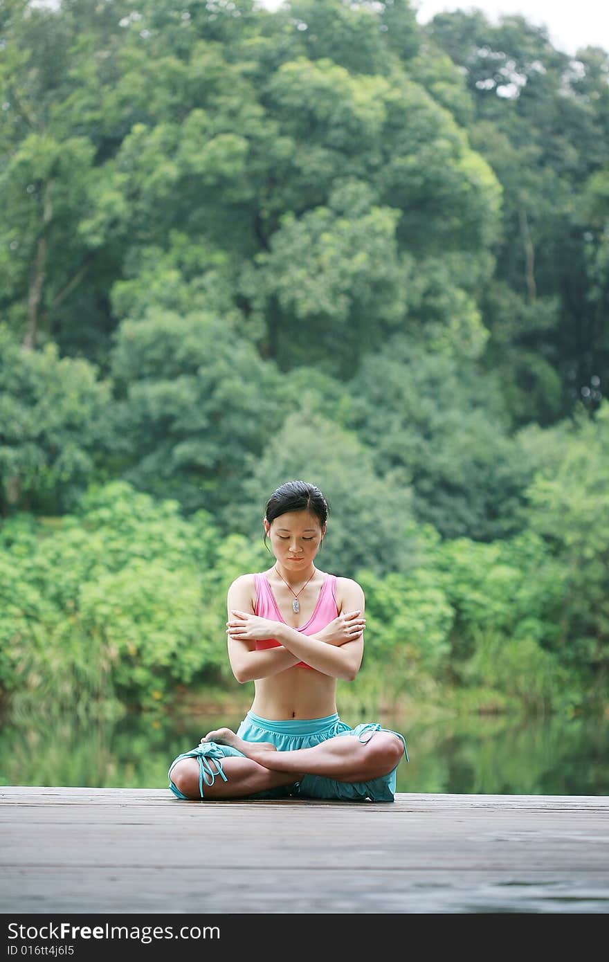 Young Chinese Woman Practicing Yoga Outdoor