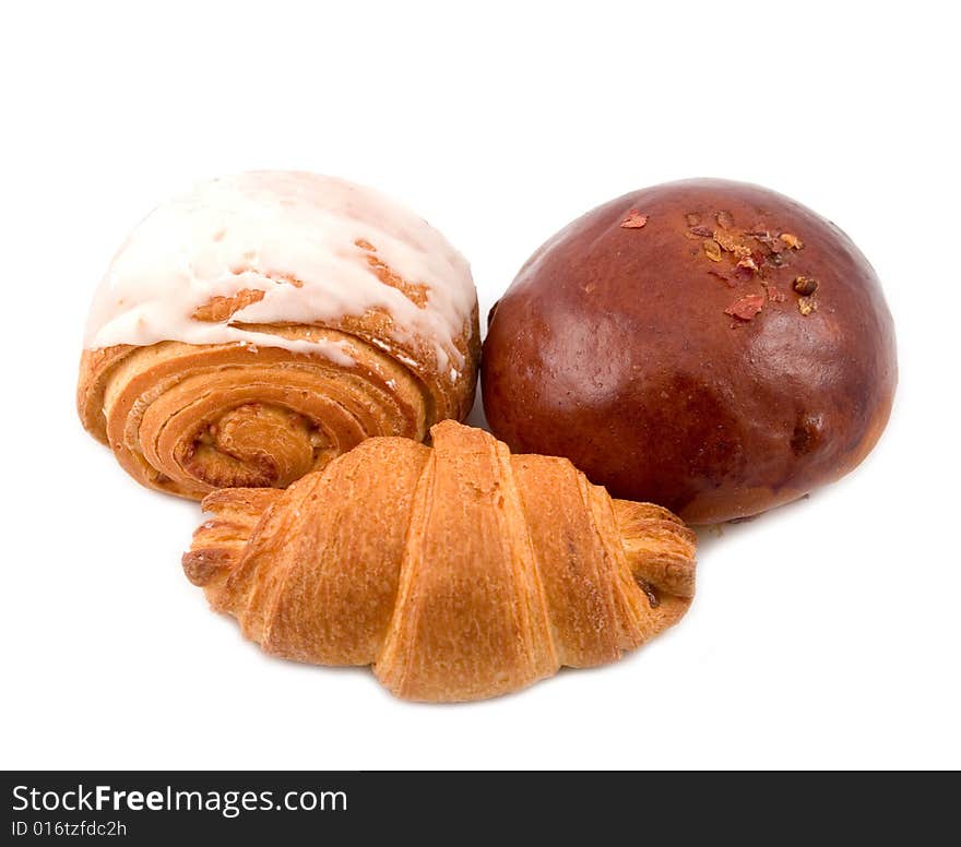 Tasty fresh beautiful rolls from puff and rich barmy test of wheat flour for white background. Tasty fresh beautiful rolls from puff and rich barmy test of wheat flour for white background