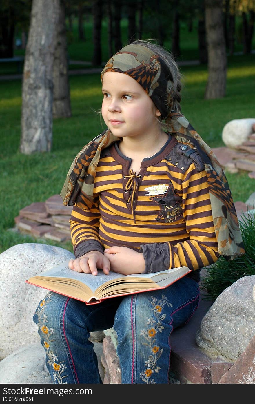 Girl reading a book in the park