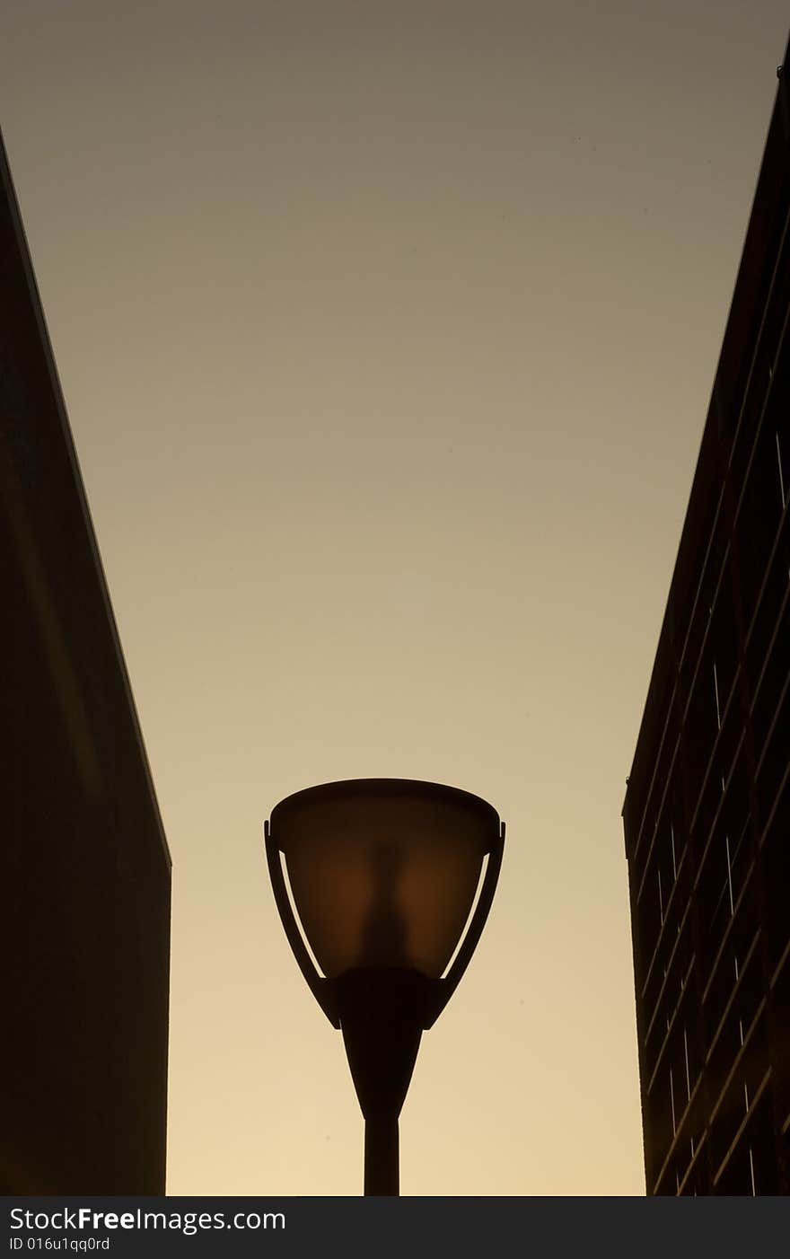 Silhouette of a modern street lamp with gradient sky