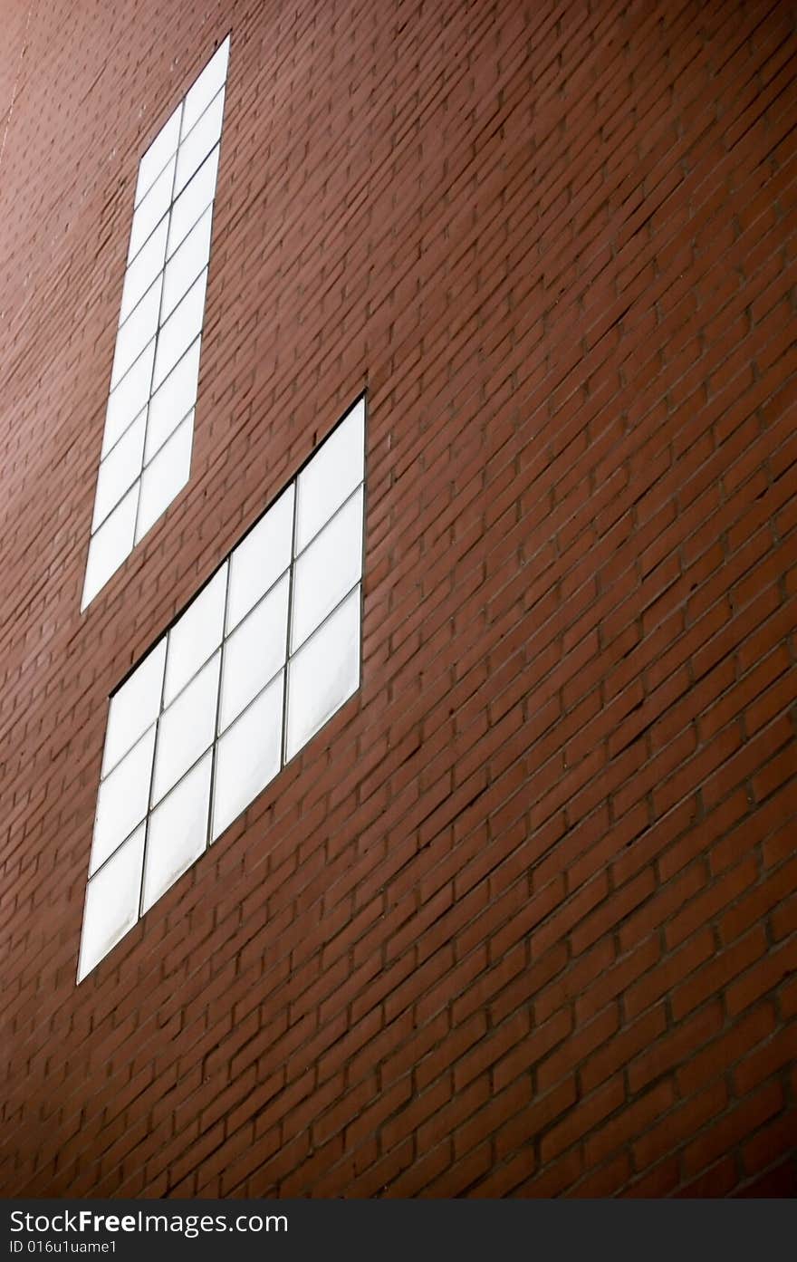 Red brick wall texture with modern glass windows