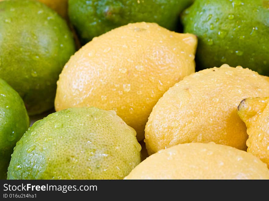 Lemon lime orange fruit set close up and water drops in the set. Lemon lime orange fruit set close up and water drops in the set