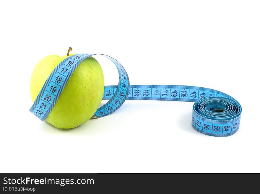 Green apple surrounded with  tape measure isolated on white. Green apple surrounded with  tape measure isolated on white