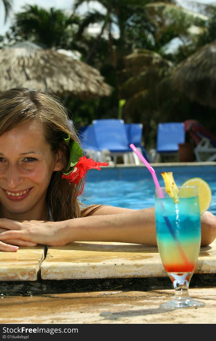 Woman in swimming pool with fresh cocktail. Woman in swimming pool with fresh cocktail