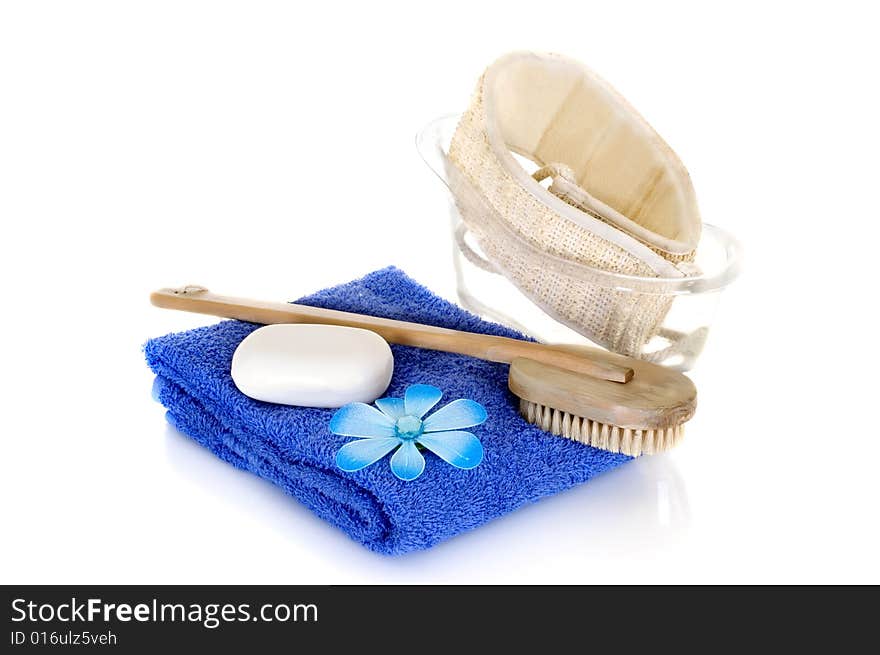 Spa essentials in blue on white background, reflective surface. Spa essentials in blue on white background, reflective surface