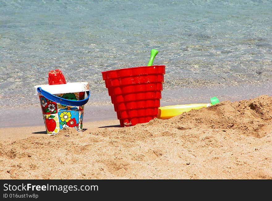 Colorful beach toys on sand