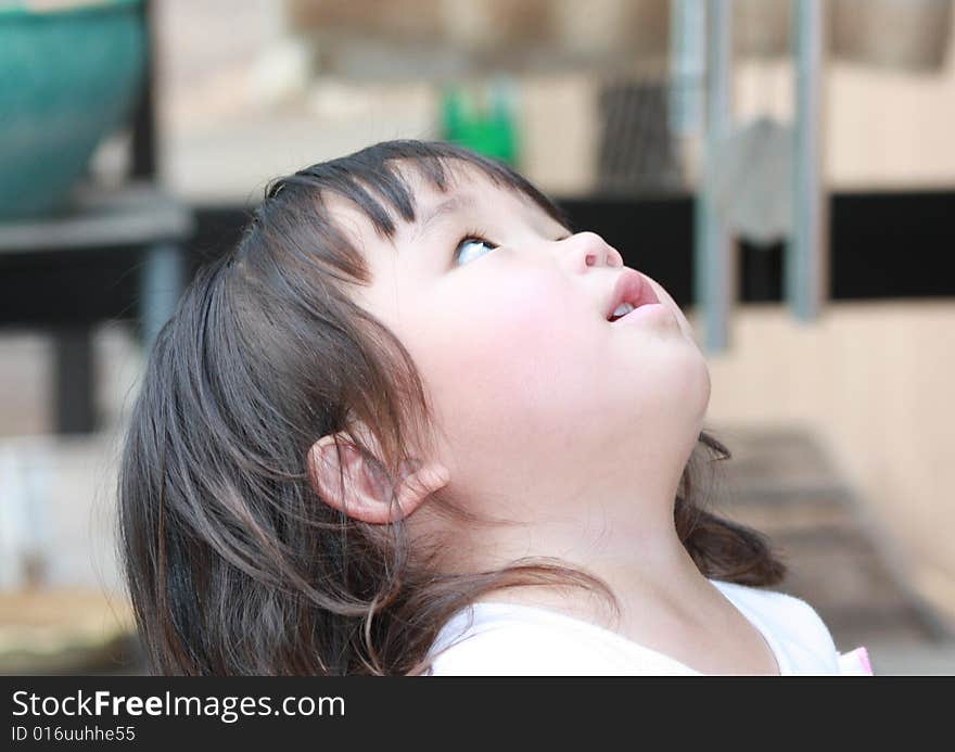 Child looking up at the object in the sky.