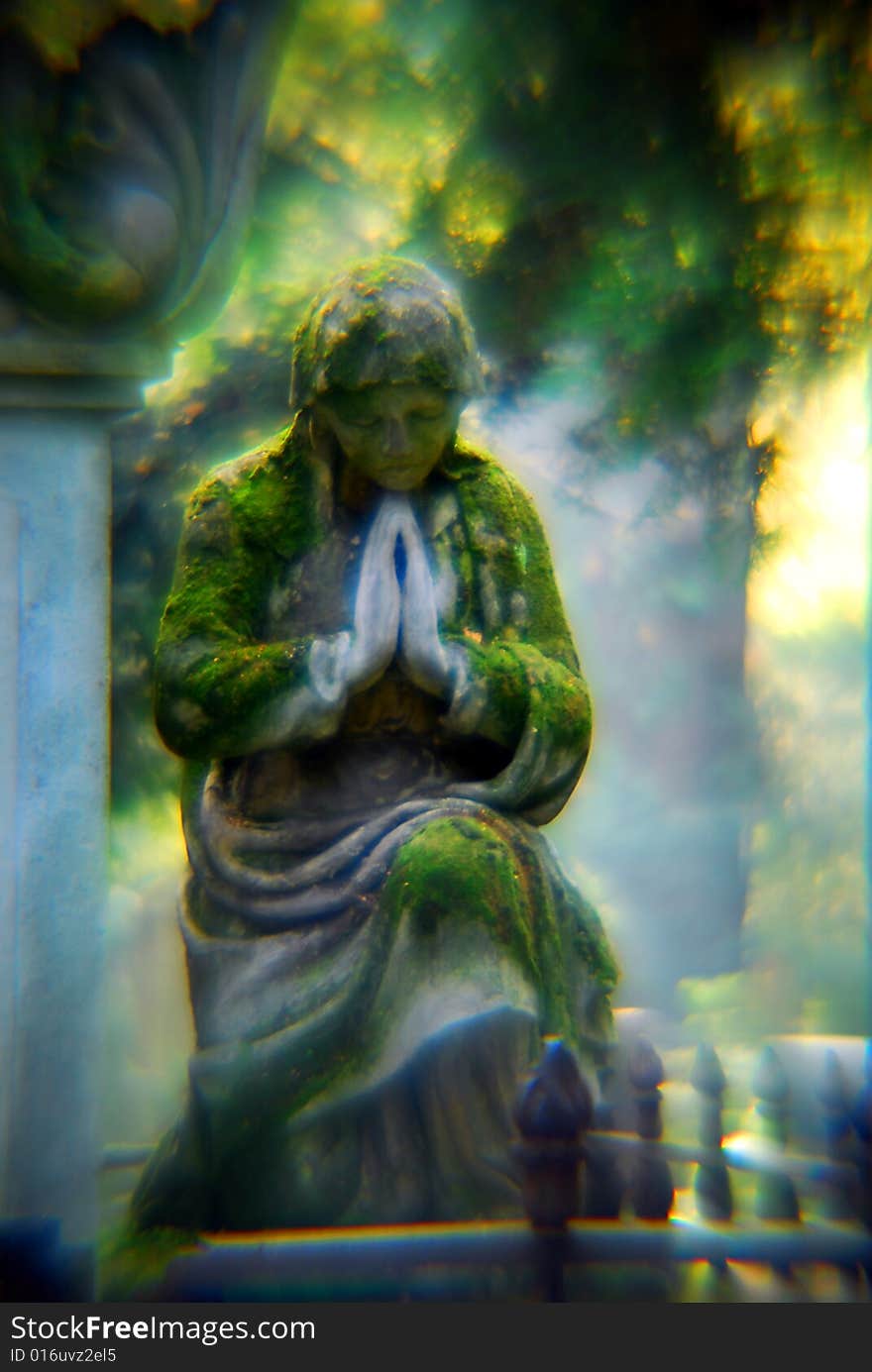 A stone woman prays eternally for the dead. A stone woman prays eternally for the dead