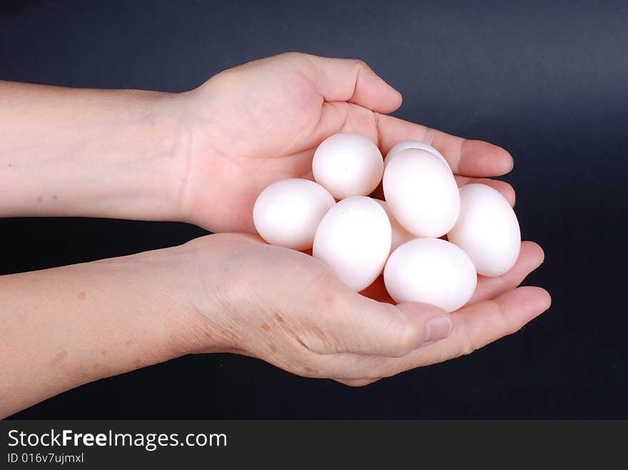 Group of eggs in  hand isolated on black background. Group of eggs in  hand isolated on black background