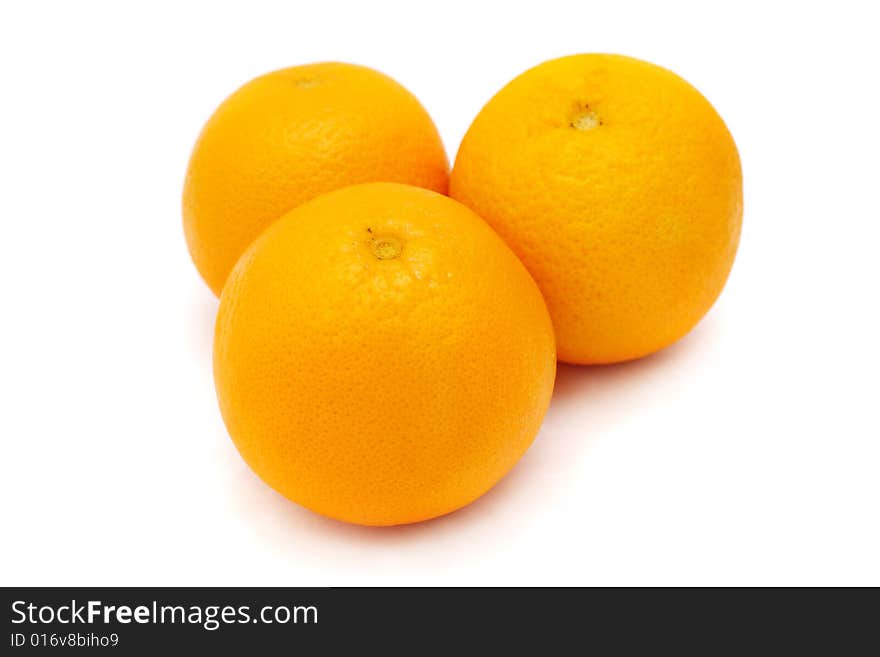 Close up of three oranges isolated on white background.