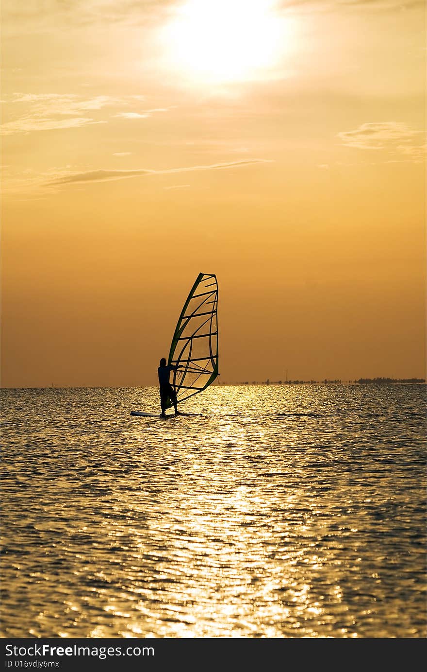 Silhouette of a windsurfer on a sunset