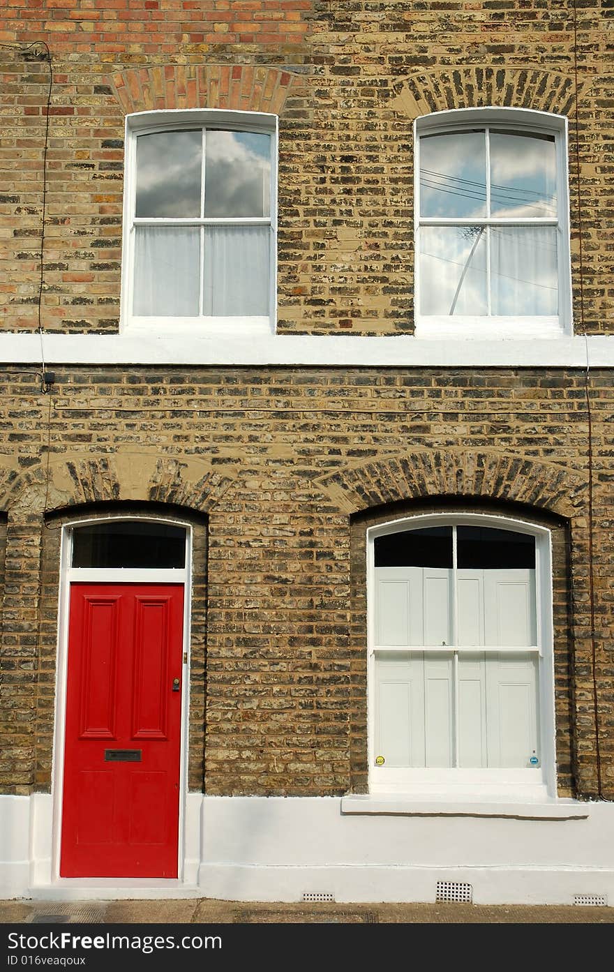 Victorian terraced house with bright red door in East London.