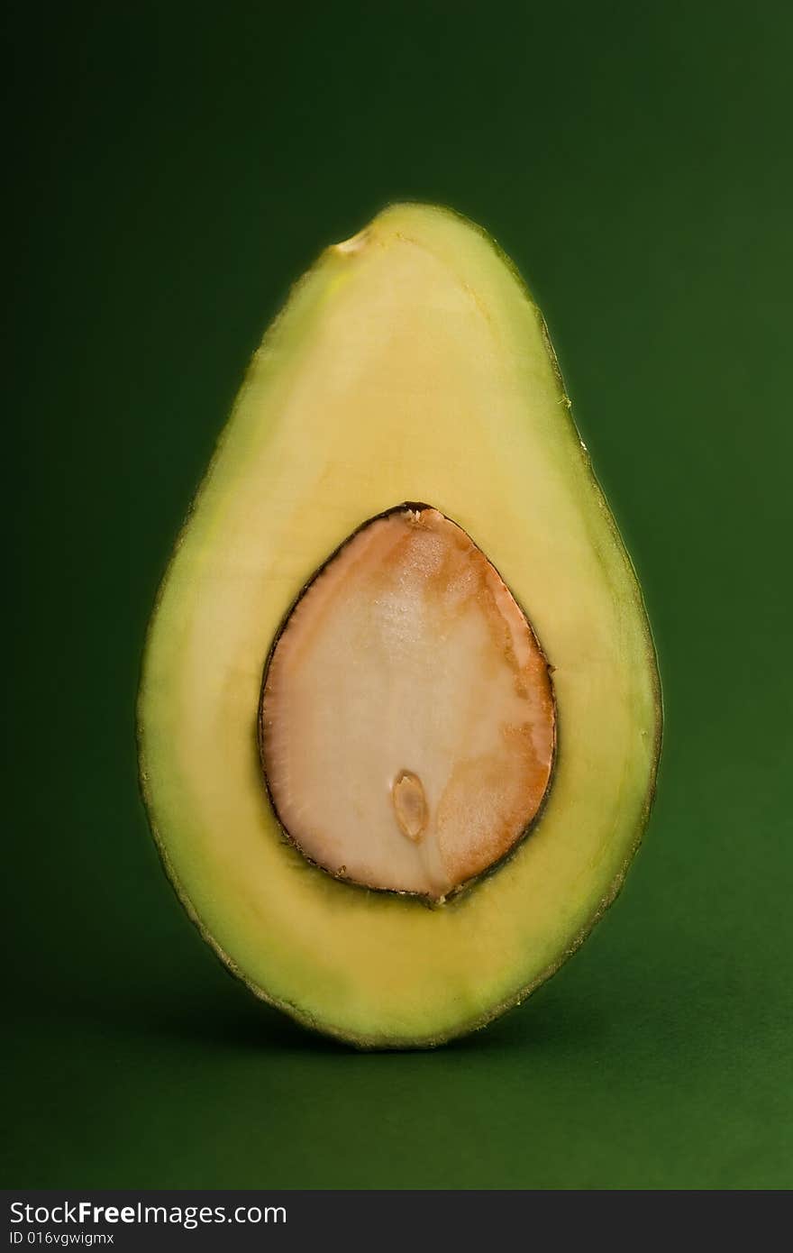 Avocado close-up isolated on green background