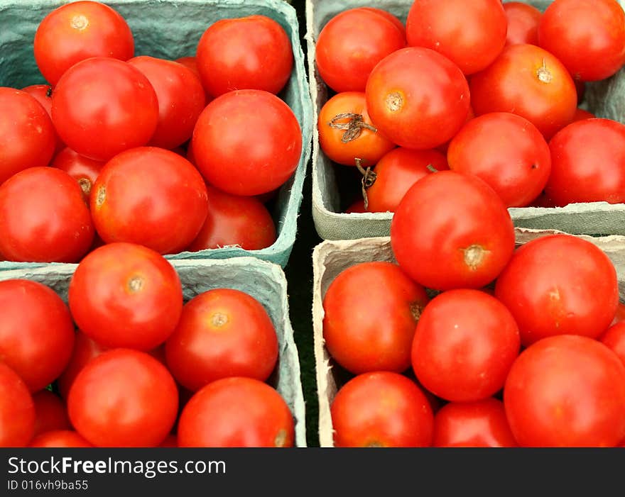 Cherry tomatoes in green baskets