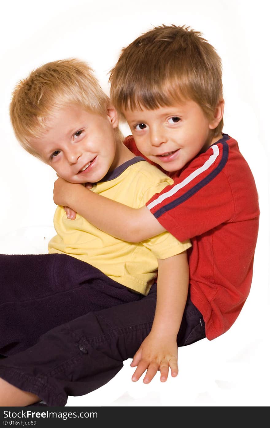 Two brothers enjoying a cuddle together.