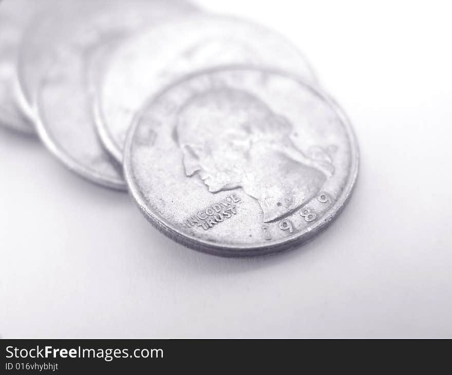 Small row of quarters over white background