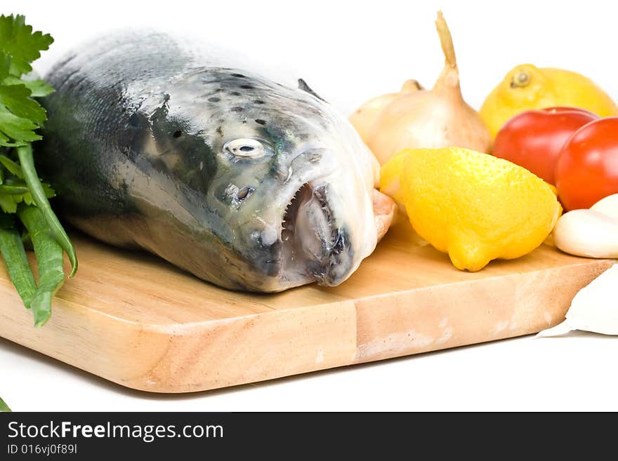 Fresh raw salmon with vegetables on a white background. Fresh raw salmon with vegetables on a white background