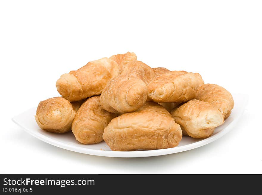 Fresh rolls on a plate on a white background