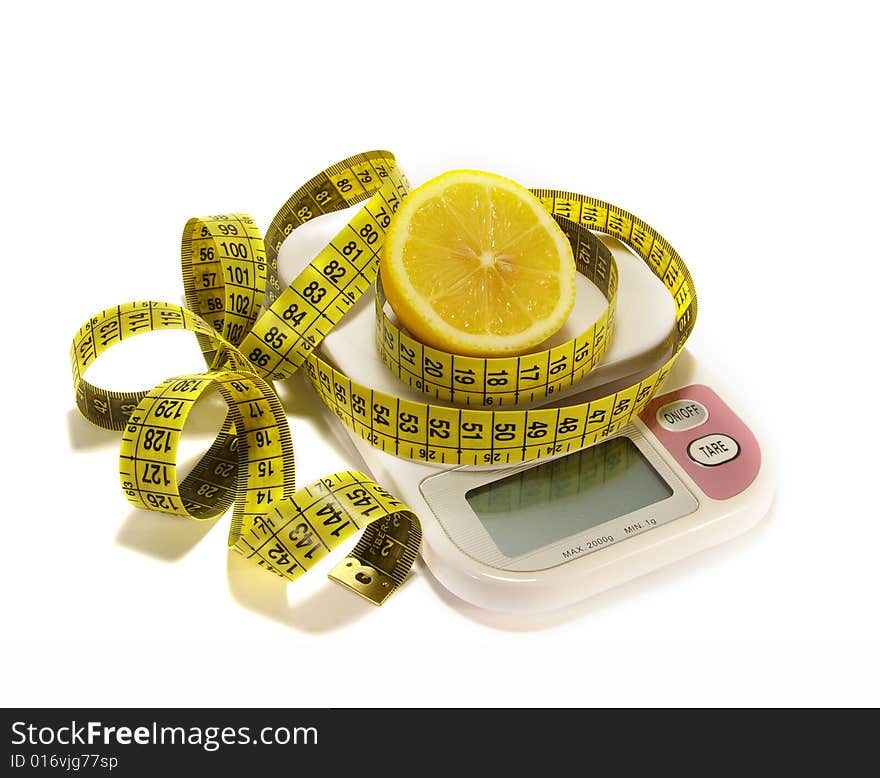 Lemon and tape measure on scale isolated. Lemon and tape measure on scale isolated