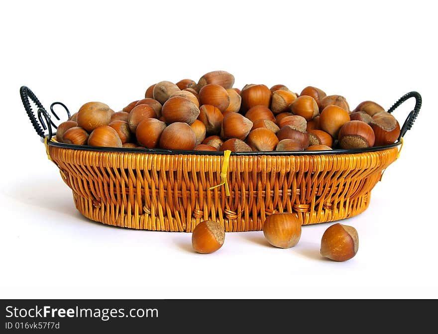 Wood nuts in a basket isolated on a white background. Wood nuts in a basket isolated on a white background