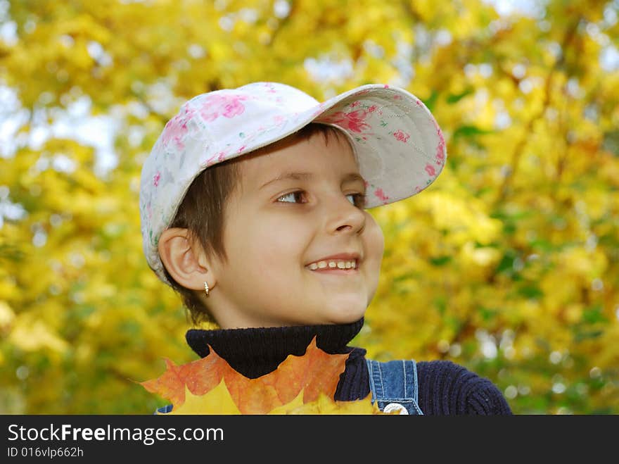 Funny happy child in autumn park